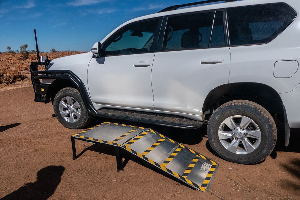 Bush ingenuity and scrap metal make boarding a high vehicle from a wheelchair quite easy.