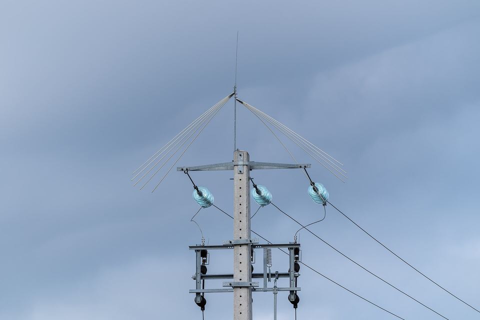 Concrete utility pole with power line insulators and bird protection, Ponte de sor, Portugal
